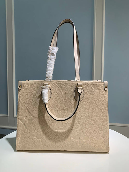 M45595 OnTheGo MM Monogram Empreinte leather white 35cm