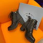 PRADA LOGO PLAQUE ANKLE BOOTS BLACK